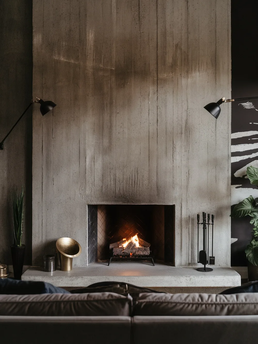 A modern living room featuring a concrete texture accent wall with a fireplace.
