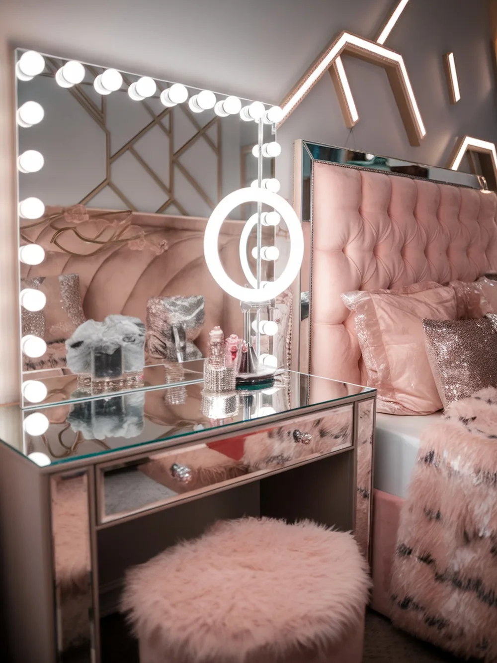 Chic teen bedroom featuring a plush pink headboard, illuminated vanity mirror, and fluffy decor.