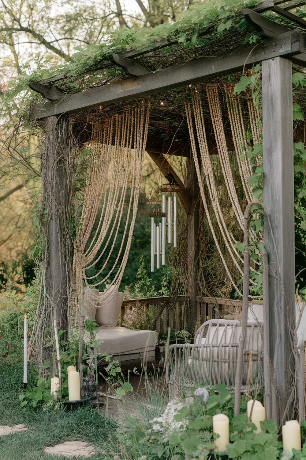 Outdoor seating area with beaded curtains and greenery
